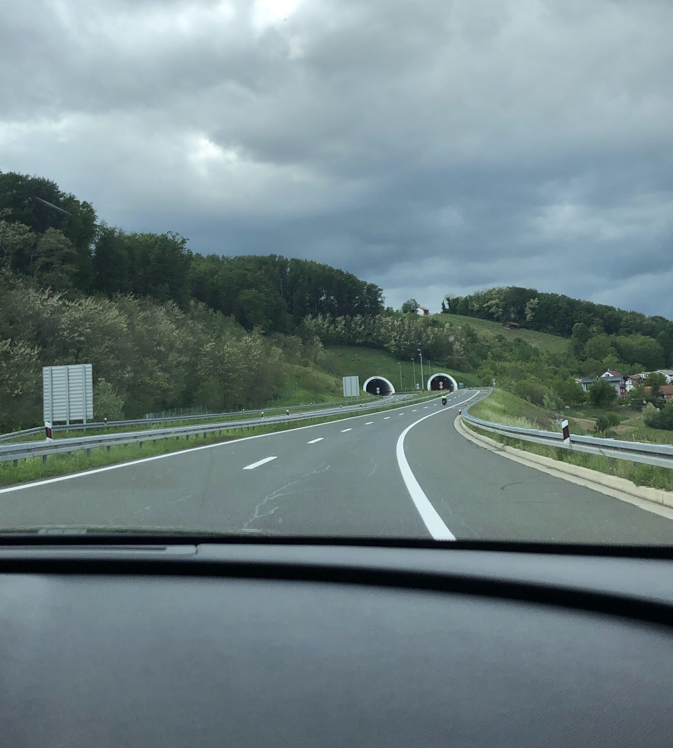 Scenic drive from Zagreb through rolling green hills and road tunnels toward northern Croatia.